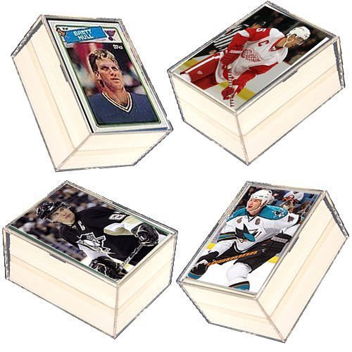 Four hockey trading cards in protective cases, angled on white background