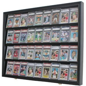 Baseball cards in protective cases displayed in a black wall-mounted cabinet
