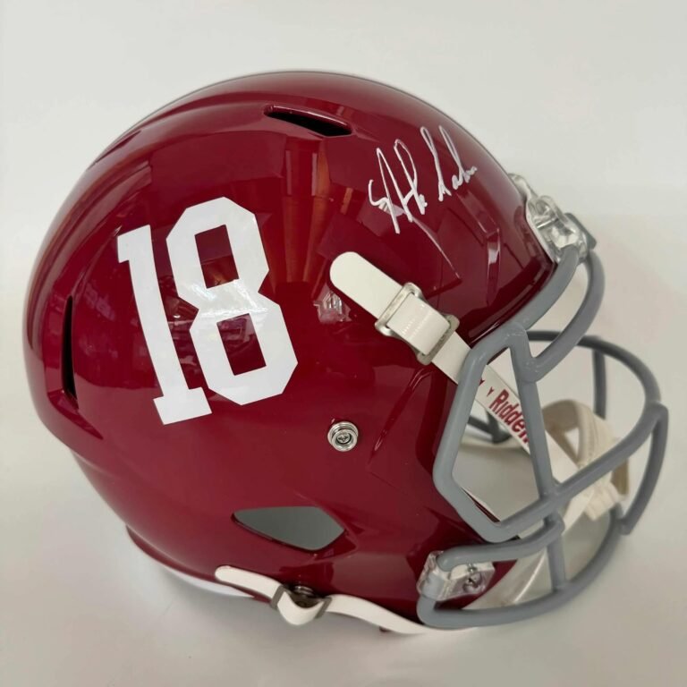 Red football helmet with the number 18 and a signature on it