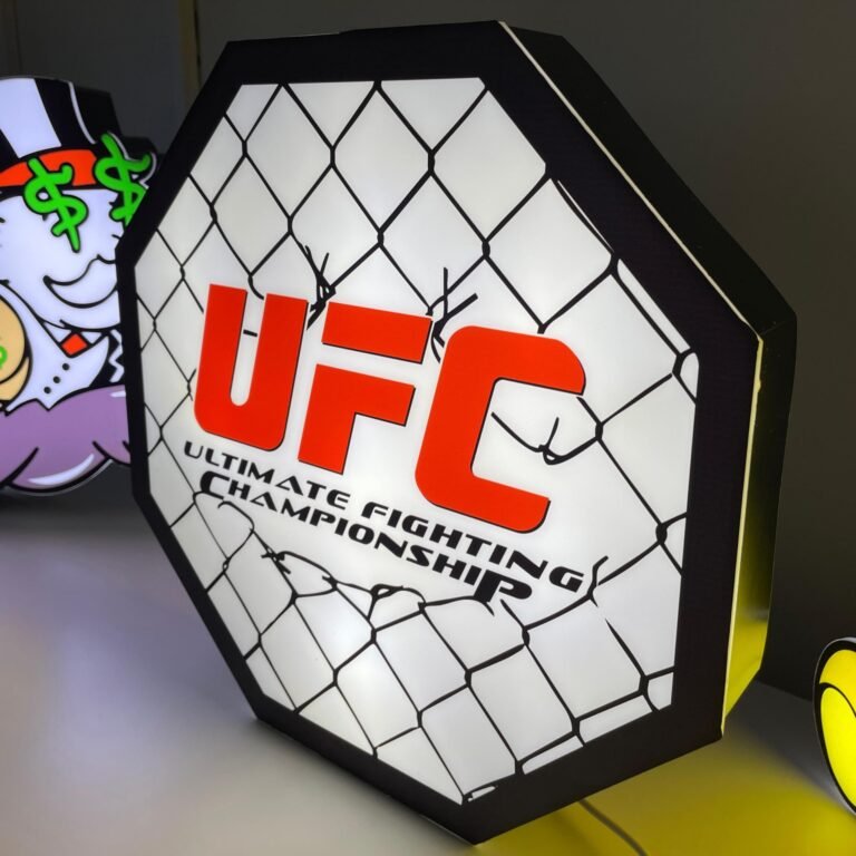UFC octagon-shaped sign with red logo and chain-link fence design