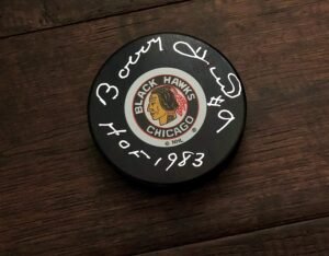 Chicago Blackhawks hockey puck with autographs on a wooden surface